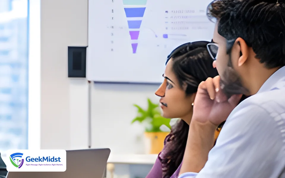 Marketing and sales colleagues discussing a lead funnel chart in a meeting
